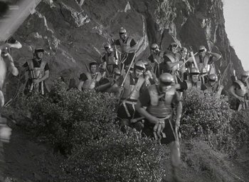 Movie still from “Julius Caesar” (1953), directed by Joseph L. Mankiewicz – A black and white photo of a group of people in helmets; Wide shot, High angle