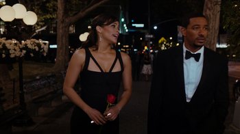 Movie still from “Jumping the Broom” (2011), directed by Salim Akil – A woman holding a red rose while standing next to a man; Medium shot, Over the shoulder angle