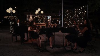 Movie still from “Jumping the Broom” (2011), directed by Salim Akil – A group of women playing musical instruments at a party; Wide shot, Low angle