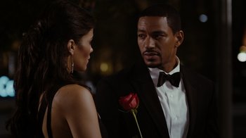 Movie still from “Jumping the Broom” (2011), directed by Salim Akil – A man and a woman standing next to each other holding a red rose; Close Up shot, Over the shoulder angle