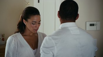 A man and a woman standing next to each other in front of a mirror