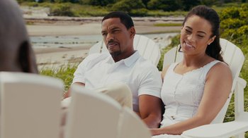 Movie still from “Jumping the Broom” (2011), directed by Salim Akil – A man and a woman sitting in lawn chairs on the beach; Medium shot, High angle