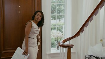 Movie still from “Jumping the Broom” (2011), directed by Salim Akil – A woman standing in front of a staircase holding a wii controller; Medium shot, Over the shoulder angle