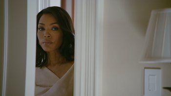 Movie still from “Jumping the Broom” (2011), directed by Salim Akil – A woman standing in front of a wall looking at the camera; Close Up shot, Over the shoulder angle