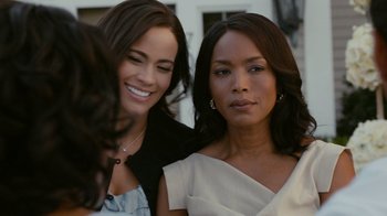 Movie still from “Jumping the Broom” (2011), directed by Salim Akil – Two beautiful women posing for a picture together; Close Up shot, Over the shoulder angle
