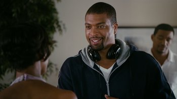 Movie still from “Jumping the Broom” (2011), directed by Salim Akil – A man with a beard wearing headphones talking to a woman; Medium shot, Over the shoulder angle