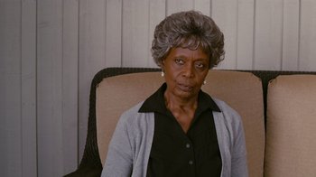 Movie still from “Jumping the Broom” (2011), directed by Salim Akil – An older woman sitting in a chair looking at the camera; Close Up shot, Over the shoulder angle