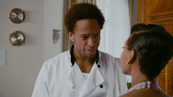 Movie still from “Jumping the Broom” (2011), directed by Salim Akil – A man in a chef's outfit talking to a woman in a kitchen; Close Up shot, Over the shoulder angle