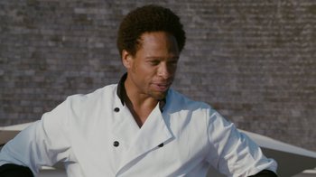 Movie still from “Jumping the Broom” (2011), directed by Salim Akil – A man in a chef's outfit standing in front of a brick wall; Close Up shot, Low angle