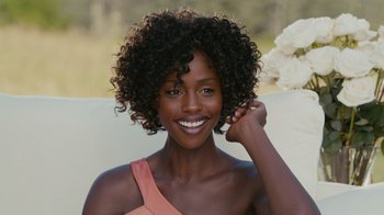 Movie still from “Jumping the Broom” (2011), directed by Salim Akil – A beautiful woman with curly hair posing for a picture; Close Up shot, Over the shoulder angle