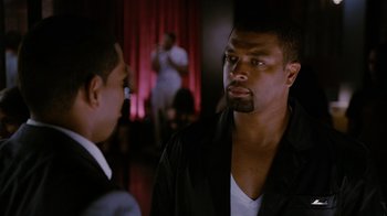 Movie still from “Jumping the Broom” (2011), directed by Salim Akil – Two men are talking in front of a red curtain; Close Up shot, Over the shoulder angle