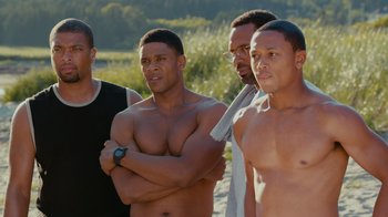 Movie still from “Jumping the Broom” (2011), directed by Salim Akil – A group of men standing next to each other on a beach; Medium shot, Over the shoulder angle