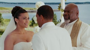Movie still from “Jumping the Broom” (2011), directed by Salim Akil – A couple getting married at a wedding ceremony; Medium shot, Over the shoulder angle