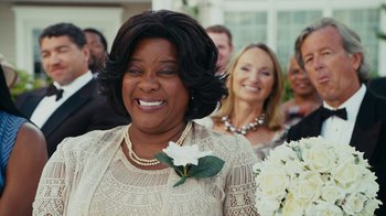 Movie still from “Jumping the Broom” (2011), directed by Salim Akil – A group of people standing in a room with flowers; Close Up shot, Over the shoulder angle