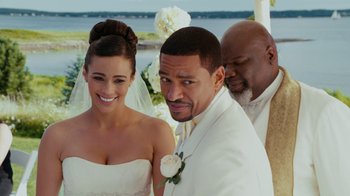 Movie still from “Jumping the Broom” (2011), directed by Salim Akil – A man and a woman standing next to each other in front of another man; Medium shot, Over the shoulder angle