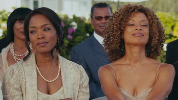 Movie still from “Jumping the Broom” (2011), directed by Salim Akil – A couple of women standing next to each other in front of a man; Close Up shot, Over the shoulder angle