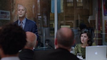 Movie still from “Junebug” (2005), directed by Phil Morrison – A group of people sitting around a table; Medium shot, Over the shoulder angle