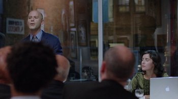 Movie still from “Junebug” (2005), directed by Phil Morrison – A group of people sitting around a table; Medium shot, Over the shoulder angle