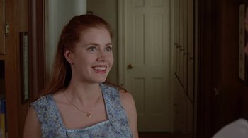 Movie still from “Junebug” (2005), directed by Phil Morrison – A woman with long red hair smiling for the camera; Close Up shot, Over the shoulder angle