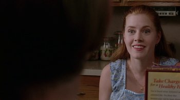 Movie still from “Junebug” (2005), directed by Phil Morrison – A person sitting in a kitchen; Close Up shot, Over the shoulder angle