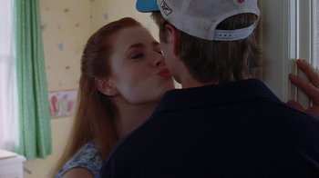 Movie still from “Junebug” (2005), directed by Phil Morrison – A man and a woman are kissing in a room; Close Up shot, Over the shoulder angle