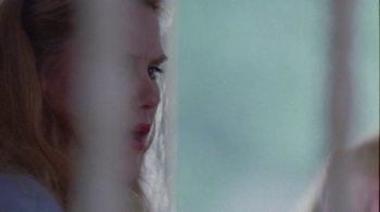 Movie still from “Junebug” (2005), directed by Phil Morrison – A woman's face looking out of a window; Extreme Close Up shot, Over the shoulder angle