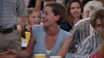 Movie still from “Junebug” (2005), directed by Phil Morrison – A group of people sitting around a table with drinks; Medium shot, Over the shoulder angle