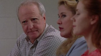 Movie still from “Junebug” (2005), directed by Phil Morrison – A man and two women sitting next to each other in a room; Close Up shot, Over the shoulder angle