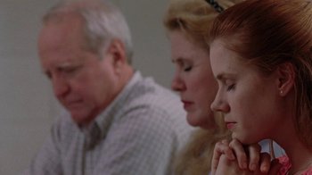 Movie still from “Junebug” (2005), directed by Phil Morrison – A group of people sitting next to each other in a room; Close Up shot, High angle
