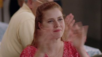 Movie still from “Junebug” (2005), directed by Phil Morrison – A woman sitting in front of an audience with her eyes closed; Close Up shot, Over the shoulder angle