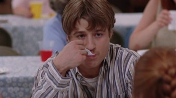 Movie still from “Junebug” (2005), directed by Phil Morrison – A young man holding a tooth brush in his mouth; Close Up shot, High angle