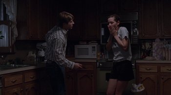 Movie still from “Junebug” (2005), directed by Phil Morrison – A man and a woman in a kitchen; Medium shot, Over the shoulder angle