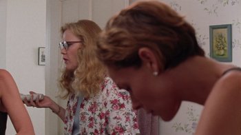 Movie still from “Junebug” (2005), directed by Phil Morrison – Two women standing next to each other in front of a wall; Medium shot, Low angle