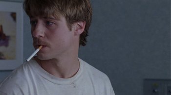 Movie still from “Junebug” (2005), directed by Phil Morrison – A man with a cigarette in his mouth; Close Up shot, Over the shoulder angle