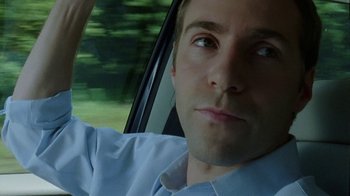 Movie still from “Junebug” (2005), directed by Phil Morrison – A person in a car; Close Up shot, Low angle