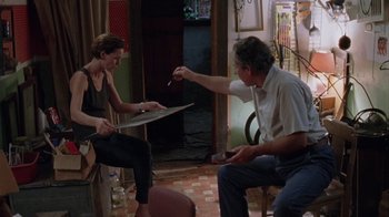 Movie still from “Junebug” (2005), directed by Phil Morrison – A man and a woman sitting in a living room; Medium shot, High angle