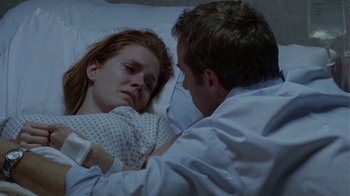 Movie still from “Junebug” (2005), directed by Phil Morrison – A man and a woman laying in a hospital bed; Close Up shot, Over the shoulder angle