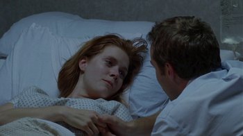 Movie still from “Junebug” (2005), directed by Phil Morrison – A man and a woman laying in a hospital bed; Close Up shot, Low angle