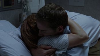 Movie still from “Junebug” (2005), directed by Phil Morrison – A man and a woman in a hospital bed hugging; Close Up shot, High angle