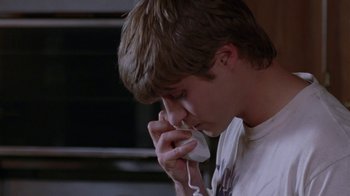 Movie still from “Junebug” (2005), directed by Phil Morrison – A young man talking on a cell phone; Close Up shot, High angle