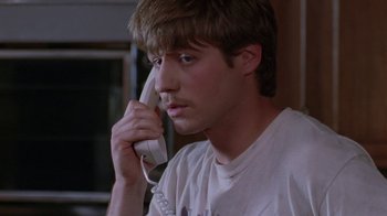 Movie still from “Junebug” (2005), directed by Phil Morrison – A man holding a phone up to his ear; Close Up shot, High angle