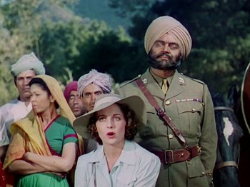Movie still from “The Jungle Book” (1942), directed by Zoltan Korda – A group of people standing next to each other wearing hats; Medium shot, Low angle