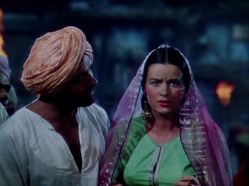 Movie still from “The Jungle Book” (1942), directed by Zoltan Korda – A man and a woman standing next to each other; Medium shot, Low angle