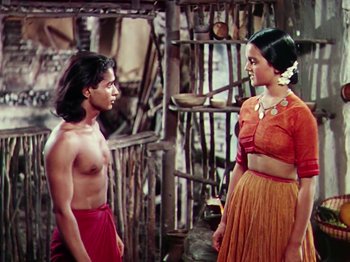 Movie still from “The Jungle Book” (1942), directed by Zoltan Korda – A man and a woman standing next to each other; Medium shot, High angle
