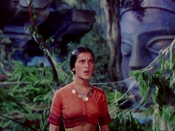 Movie still from “The Jungle Book” (1942), directed by Zoltan Korda – A woman standing in front of a forest with trees; Medium shot, Low angle