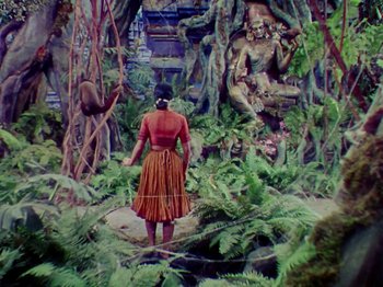 Movie still from “The Jungle Book” (1942), directed by Zoltan Korda – A painting of a woman standing in the jungle; Wide shot, High angle