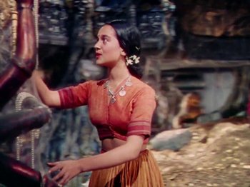 Movie still from “The Jungle Book” (1942), directed by Zoltan Korda – A woman in an orange shirt is holding a rope; Medium shot, Low angle