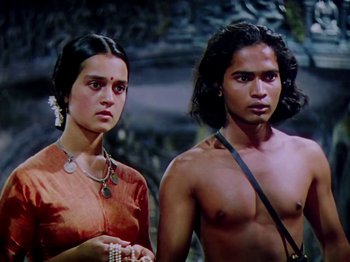 Movie still from “The Jungle Book” (1942), directed by Zoltan Korda – A man and a woman standing next to each other; Medium shot, High angle