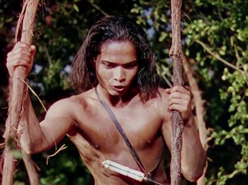 Movie still from “The Jungle Book” (1942), directed by Zoltan Korda – A man with long hair holding a stick; Medium shot, Low angle