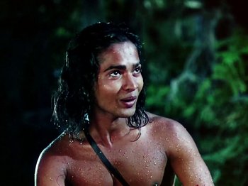 Movie still from “The Jungle Book” (1942), directed by Zoltan Korda – A shirtless man with wet hair is looking at the camera; Close Up shot, High angle